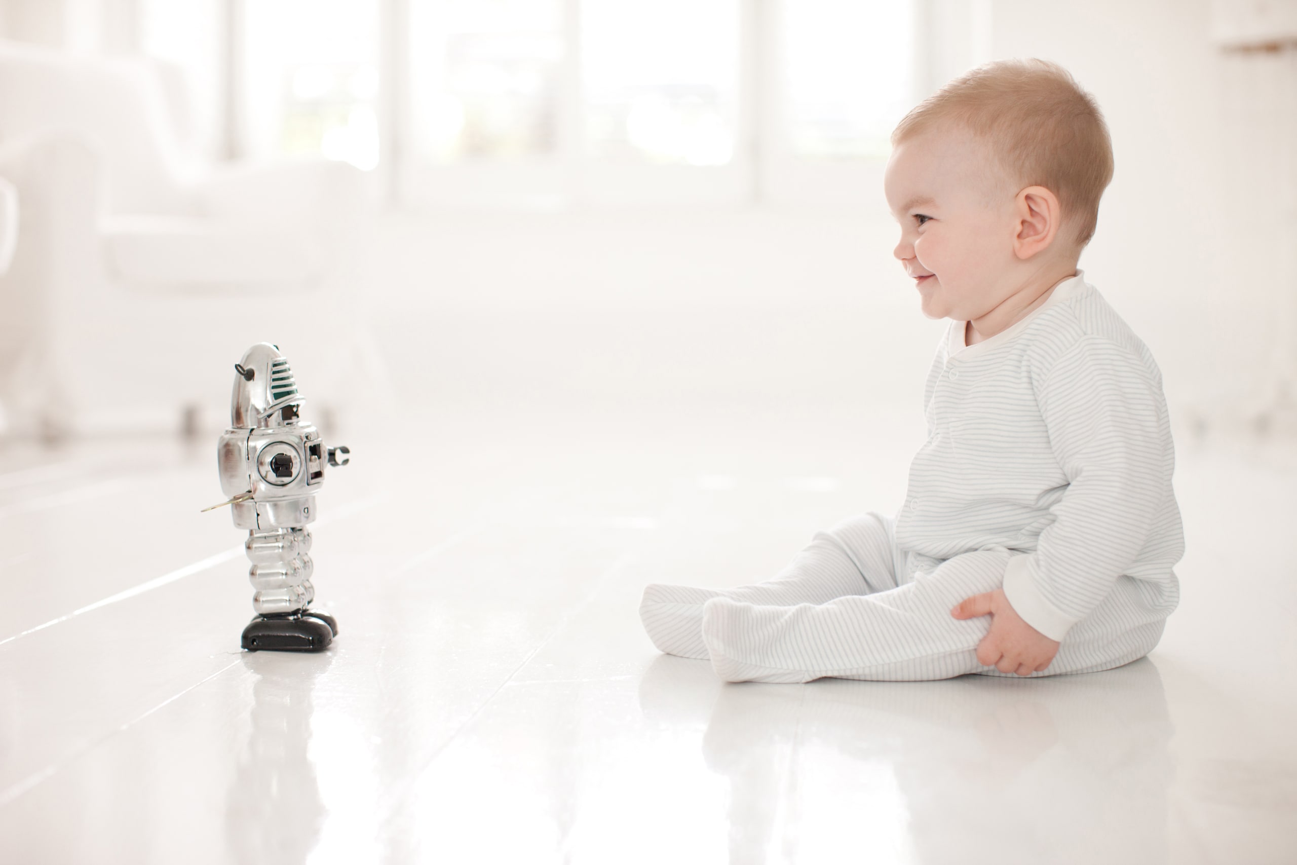 Figure 1: Newborn humans and robots struggle with the challenging tasks of balance and motion. 